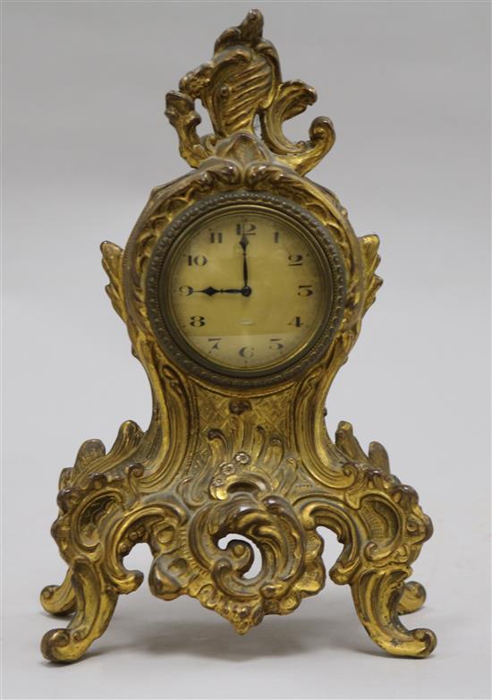 A small Louis XV style gilt cast metal eight day mantel timepiece 20cm.